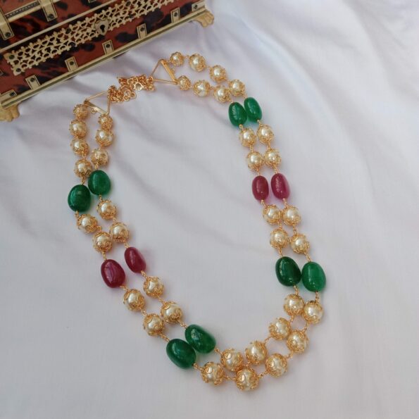 Two layer pearl chain with red and green bead